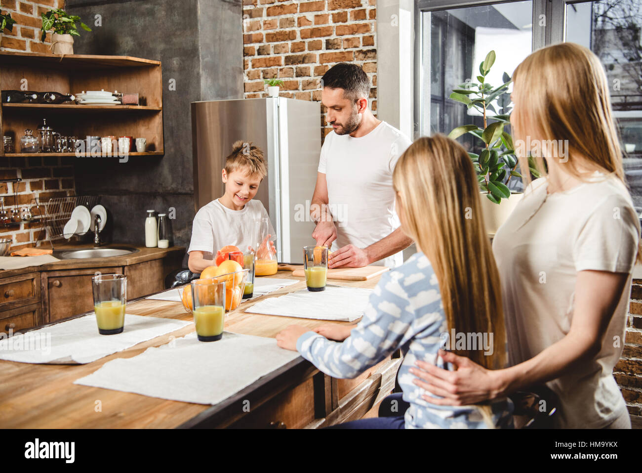 Family makes orange juice Stock Photo Alamy