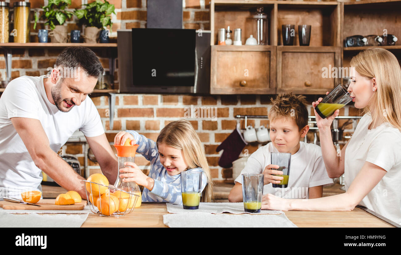Family makes orange juice Stock Photo Alamy