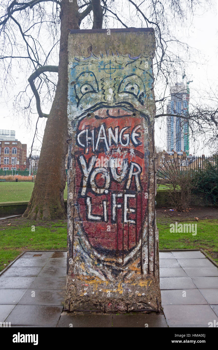 London, Southwark   A section of the Berlin Wall at the Imperial War Museum, featuring the 'Change Your Life' mural by Indiano Stock Photo
