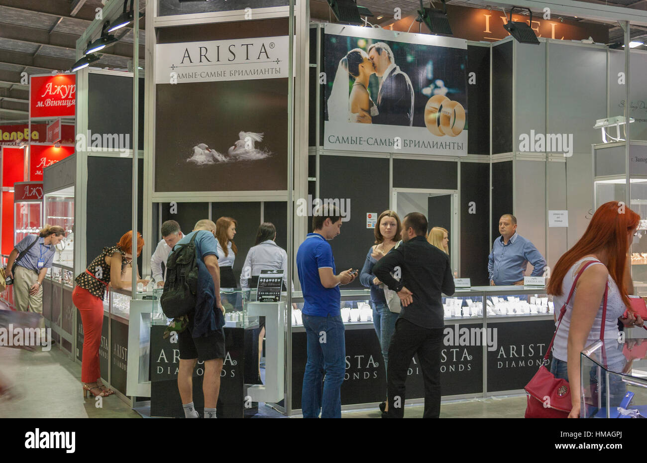 Visitors visit Arista Diamonds Jewelry House booth with presenters