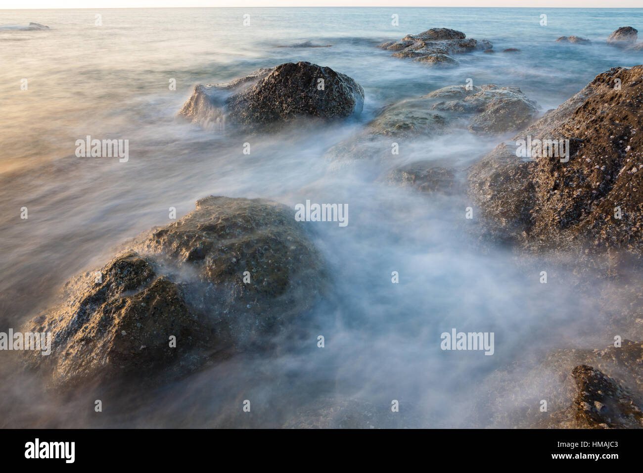 Waves and rocks shore long exposure Stock Photo - Alamy