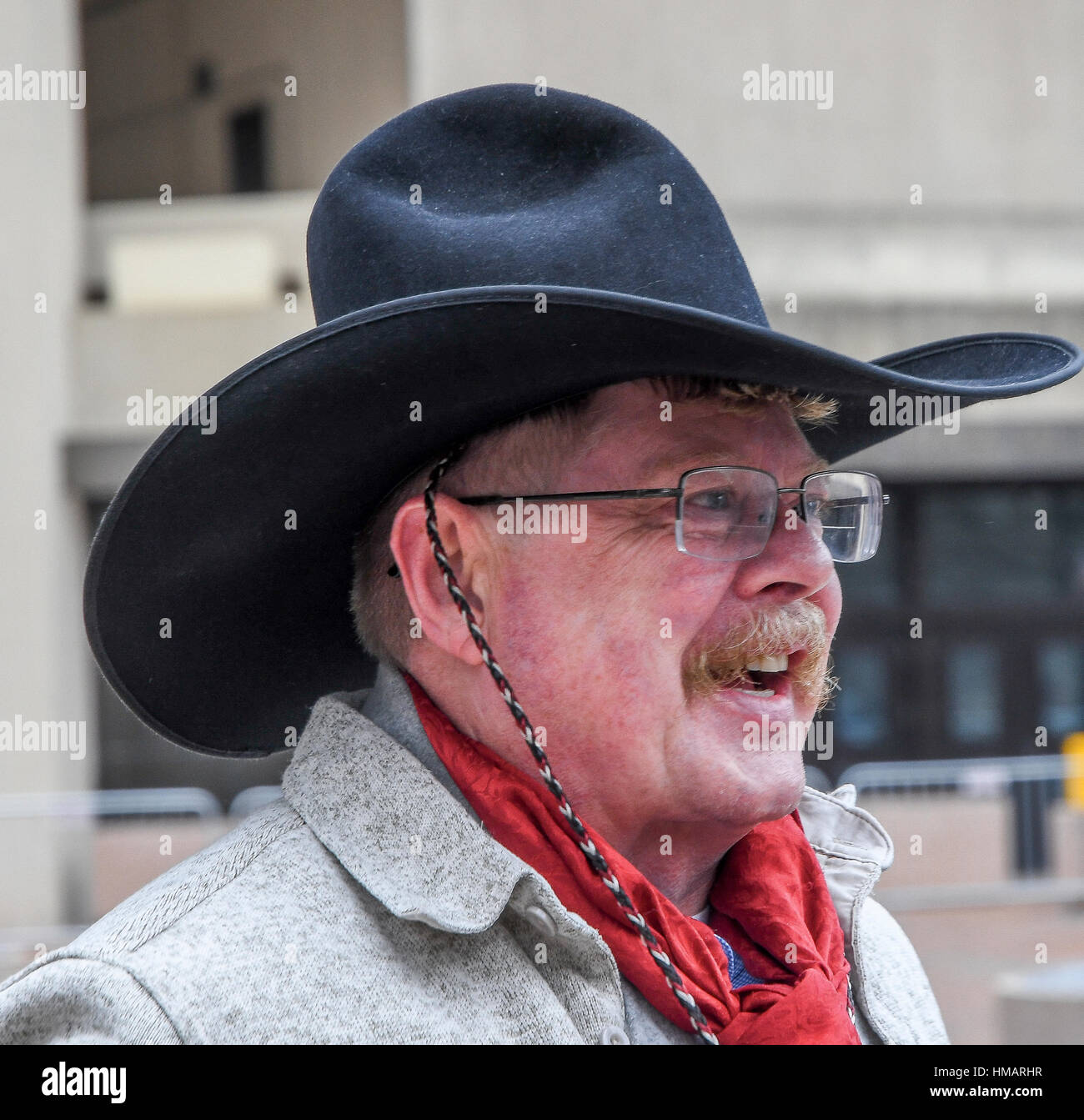 Washington, DC. USA, 21th January, 2017 Man wearing a 'Tom Mix' style cowboy hat watches the Womans Protest March on Washington DC. from the sidewalk Stock Photo