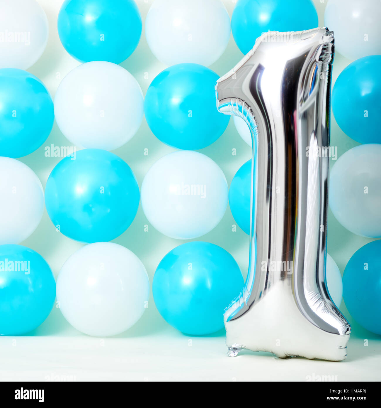 Shiny First Birthday Balloon With Blue And White Balloons Background