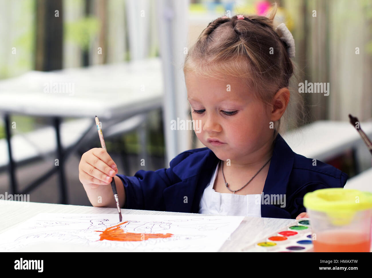 Cute little girl painting watercolors Stock Photo - Alamy