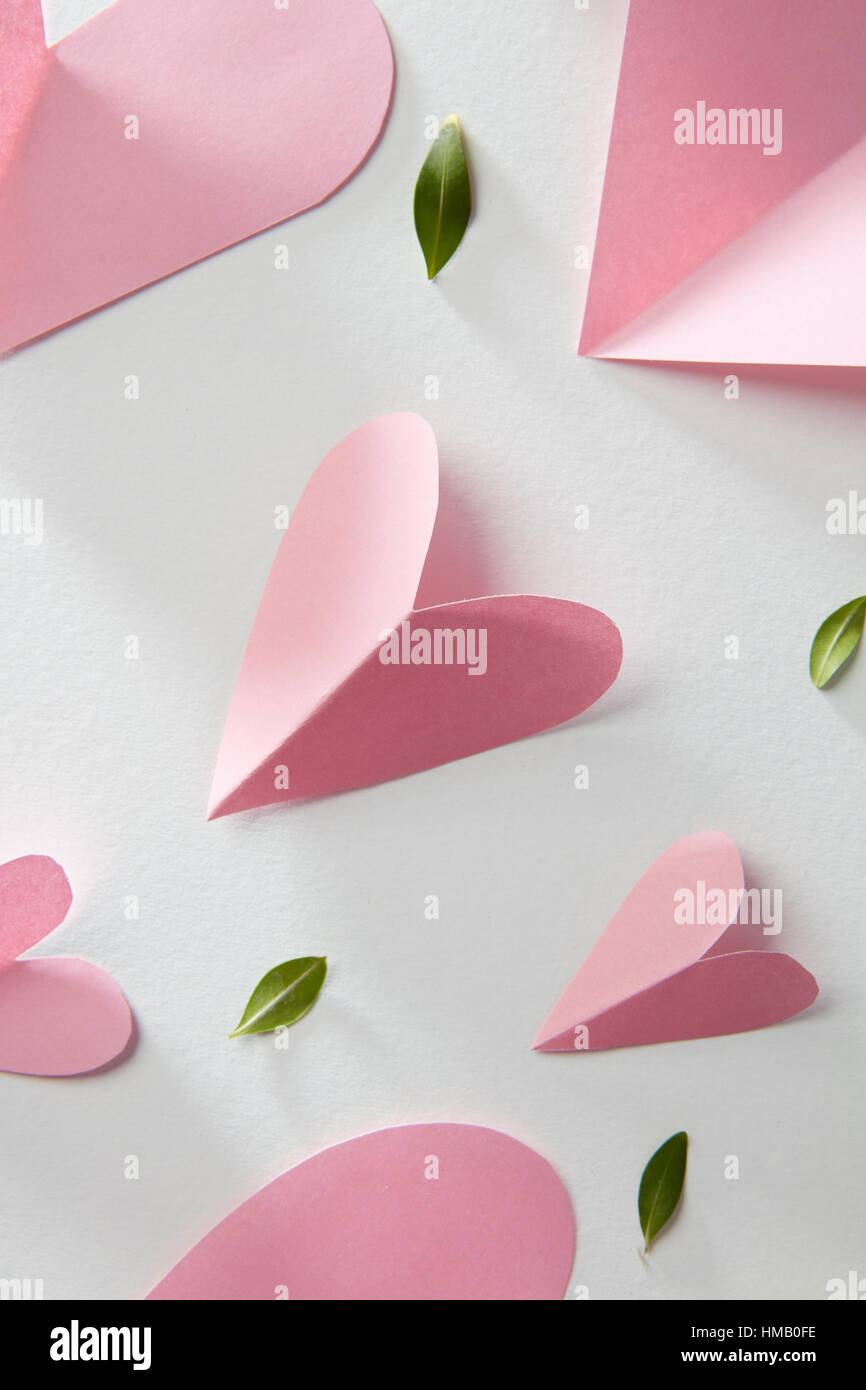 Paper pink hearts and leaves isolated on white Stock Photo - Alamy