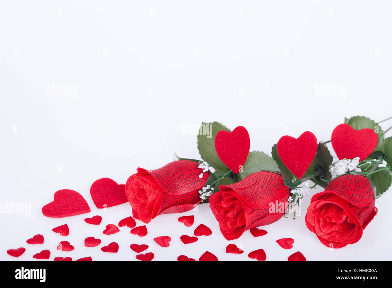 Red roses and red hearts on a white background Stock Photo - Alamy