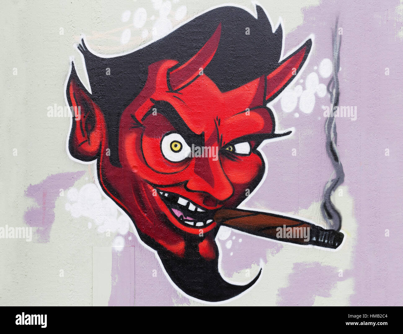 Red devil smoking cigar, graffiti, urban art, street art, Düsseldorf, North Rhine-Westphalia, Germany Stock Photo