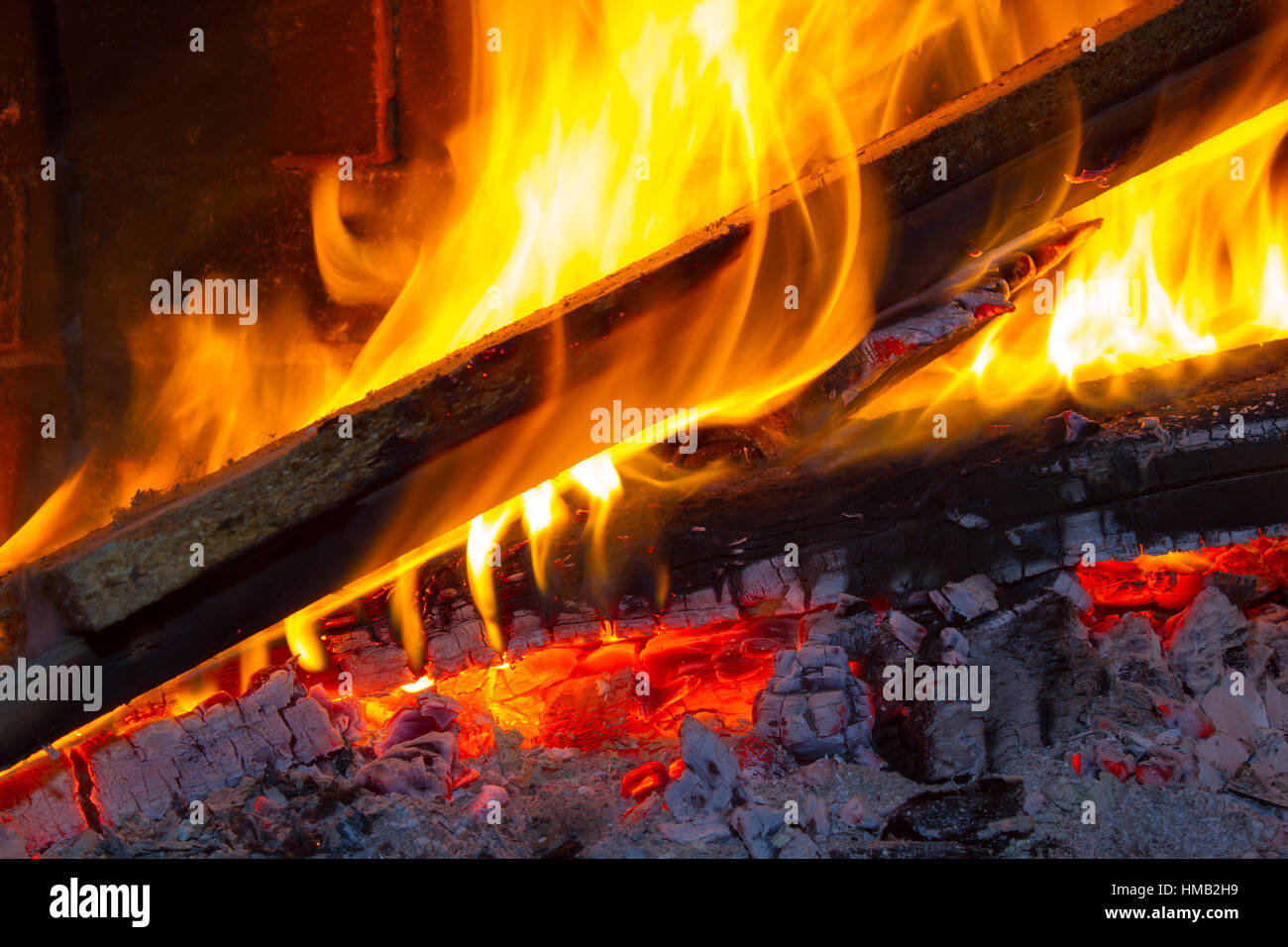 brightly burning wood in a fireplace Stock Photo Alamy