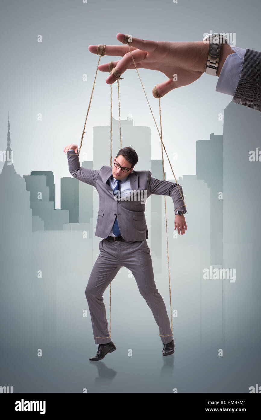 Businessman puppet being manipulated by boss Stock Photo Alamy