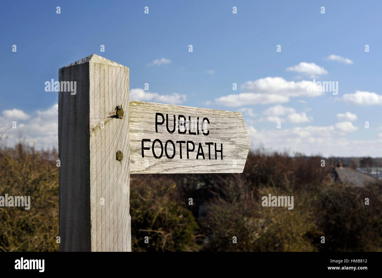 Wooden Public Footpath right of way finger post sign in the countryside. Stock Photo