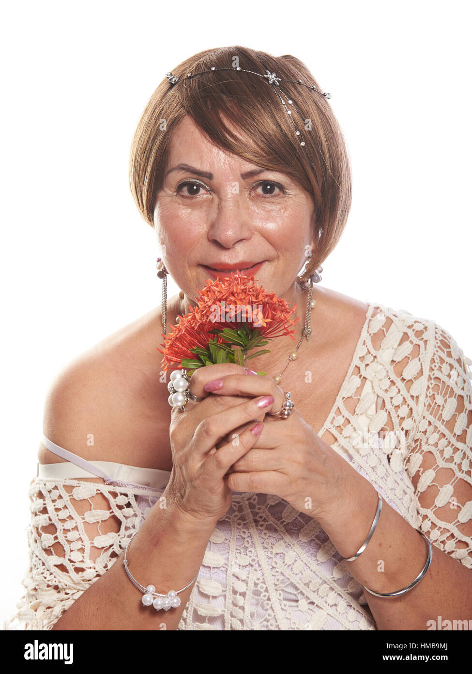 mature lady with flowers posing on a white background Stock Photo