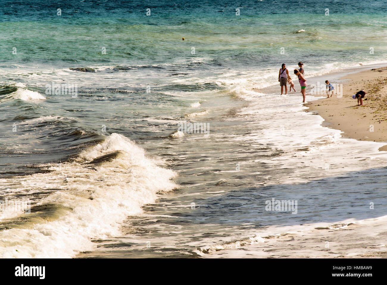 Sunny beach, Bulgaria - calm sea waves and several people enjoying their vacation during the summer Stock Photo