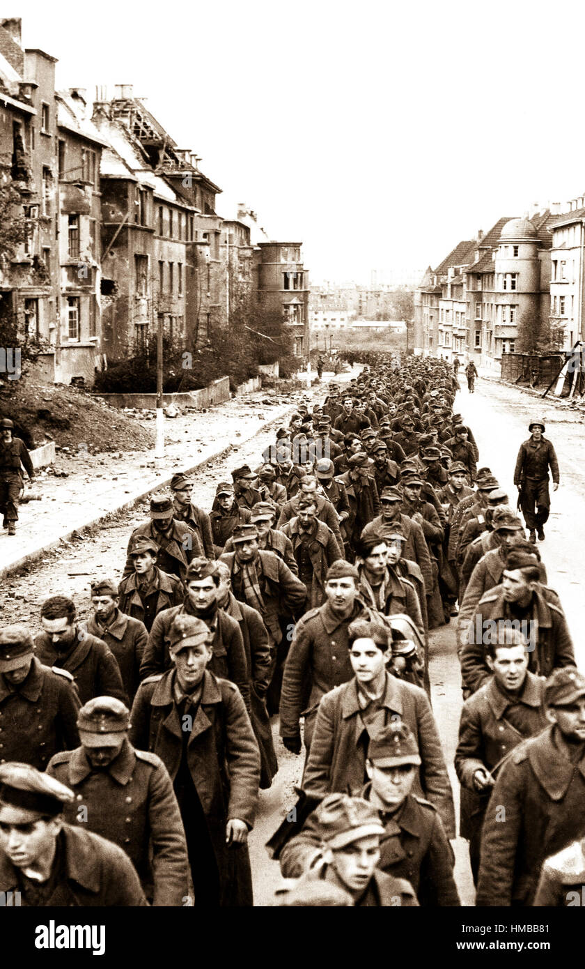 The endless procession of German prisoners captured with the fall of Aachen marching through the ruined city streets to captivity.  Germany, October 1944.  Associated Press Ltd.  (U.S. Occupation Headquarters) Exact Date Shot Unknown NARA FILE #:  260-MGG-1061-1 WAR & CONFLICT BOOK #:  1290 Stock Photo