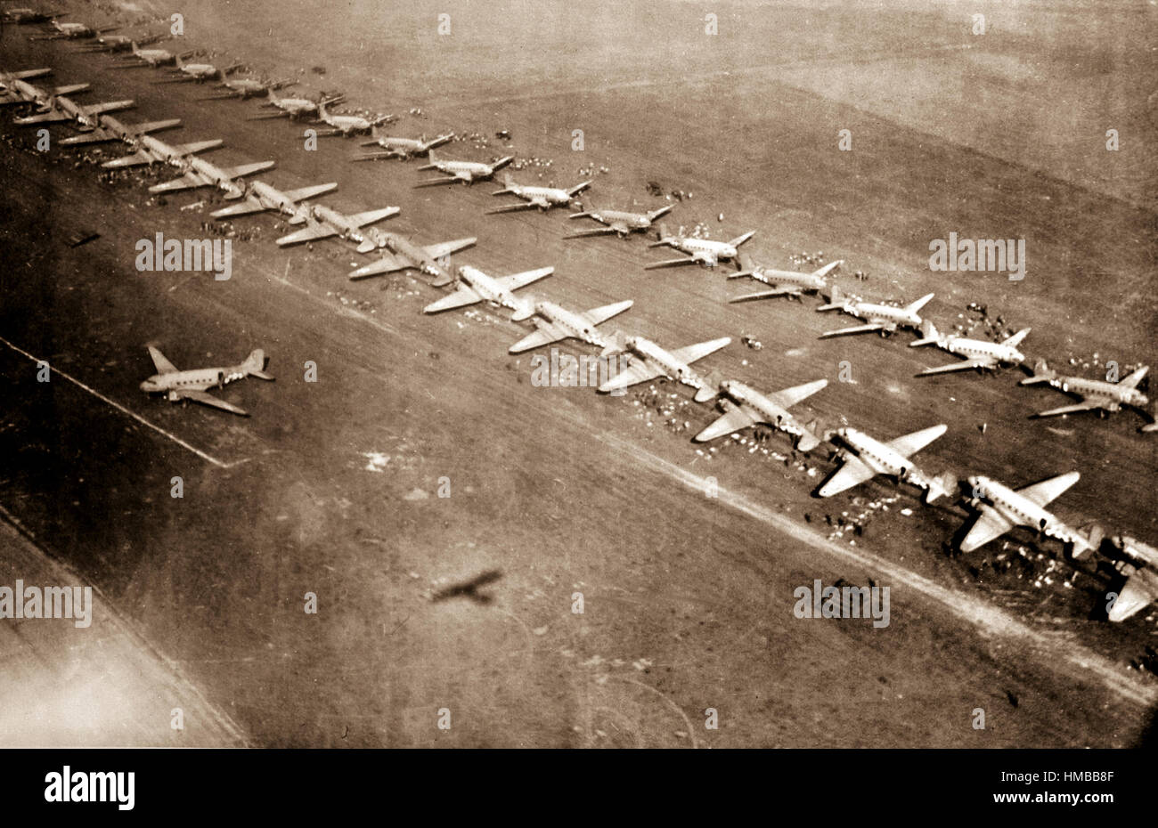 Long, twin lines of C-47 transport planes are loaded with men equipment at an airfield from which they took off for Holland September 17, 1944.  The C-47's carried paratroopers of the First Allied Airbone Army.  England. (Army)  NARA FILE #:  208-AA-56T-4  WAR & CONFLICT BOOK #:  1063 Stock Photo