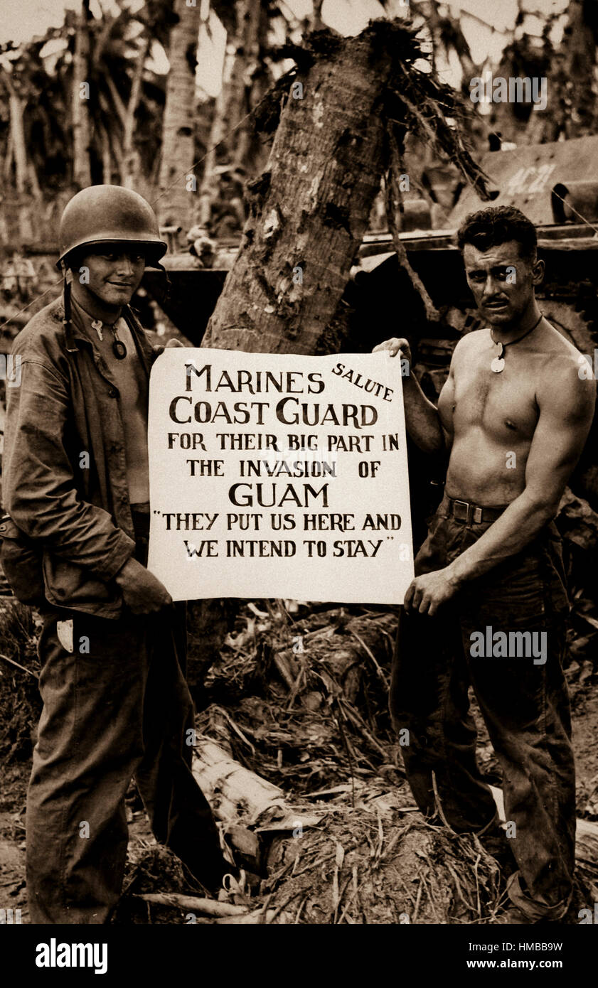 The U.S. Marines salute the U.S. Coast Guard after the fury of battle had subsided and the Japs on Guam had been defeated.  'They (the Coast Guard) Put Us Here and We Intend to Stay' is the way the Marines felt about it. Ca. August 1944 (Coast Guard) Exact Date Shot Unknown NARA FILE #:  026-G-2708 WAR & CONFLICT BOOK #:  1196 Stock Photo