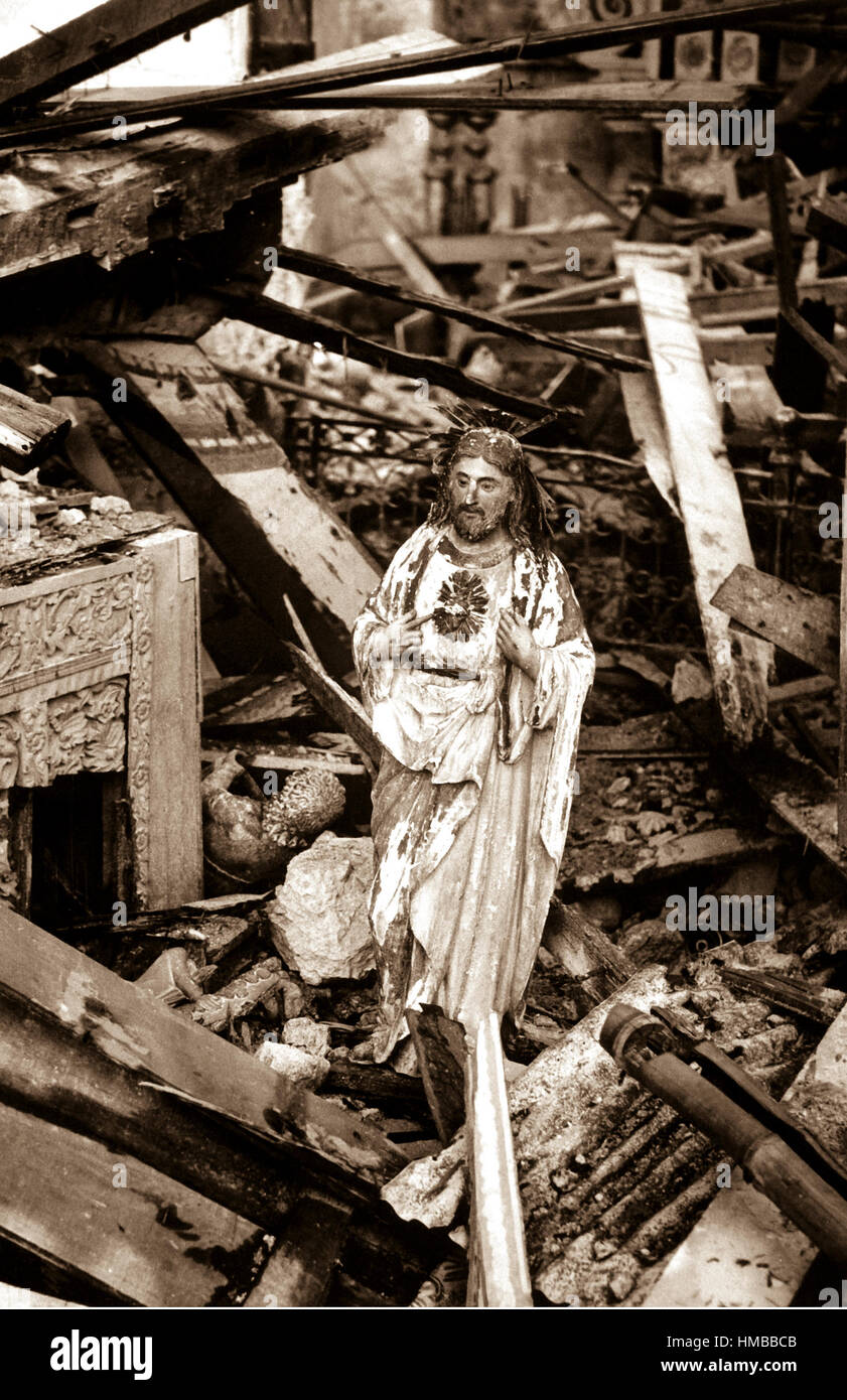 Still standing in the rubble of a church in the war-blasted town of Dulag, a statue of the sacred heart appears to gaze in quiet sorrow on the destruction wrought by battle's fury seething over Leyte Island, Philippines, 1944.  (Coast Guard) Exact Date Shot Unknown NARA FILE #:  026-G-3577 WAR & CONFLICT BOOK #:  1331 Stock Photo