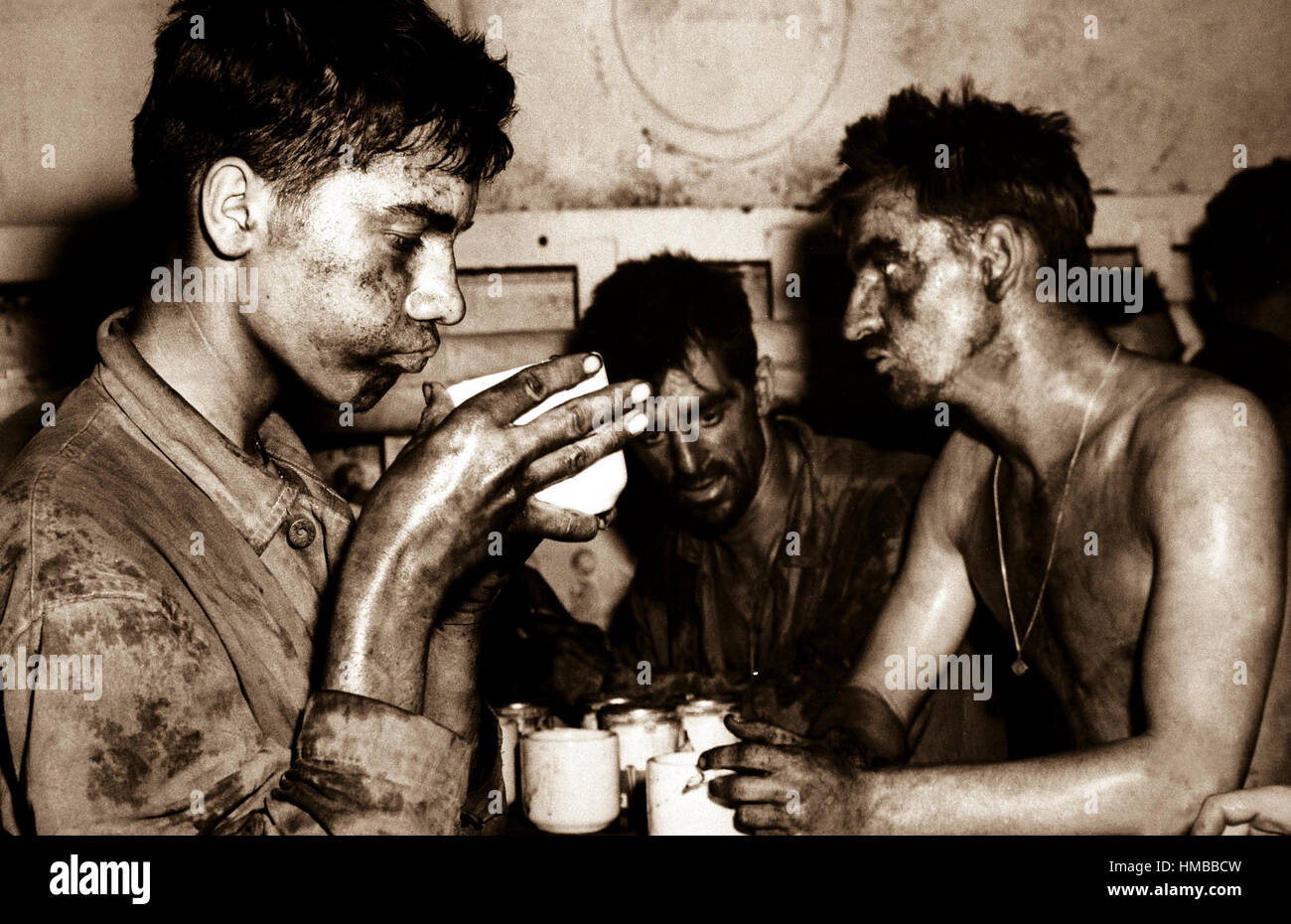 These Marines, begrimed and weary from two days and two nights of fighting, are typical of the conquerors of Eniwetok Atoll.  Pfc. Faris M. (Bob) Tuohy, 19, is the Marine holding the coffee cup.  Ca.  1944.  CPhoM. Ray R. Platnick.  (Coast Guard) Exact Date Shot Unknown NARA FILE #:  026-G-3345 WAR & CONFLICT BOOK #:  926 Stock Photo