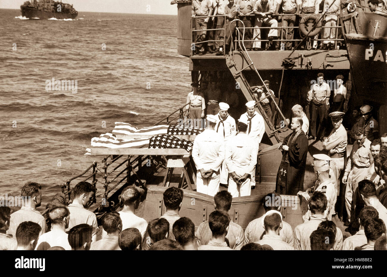 Two enlisted men of the ill-fated U.S. Navy aircraft carrier Liscome Bay, torpedoed by a Japanese submarine in the Gilbert Islands, are buried at sea from the deck of a Coast Guard-manned assault transport.  November 1943.  (Coast Guard) Exact Date Shot Unknown NARA FILE #:  026-G-3182 WAR & CONFLICT BOOK #:  1344 Stock Photo