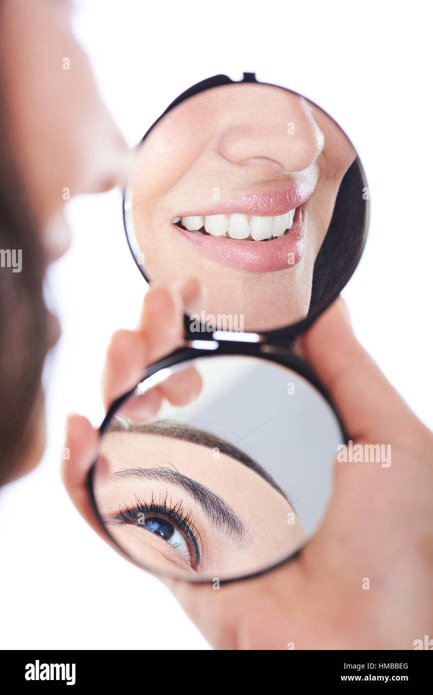 close up reflection of woman smile in mirror isolated on white Stock Photo