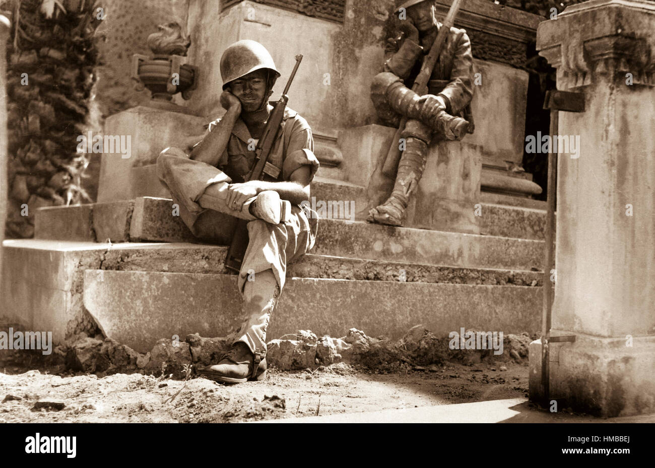 Sgt. Norwood Dorman, Benson, N.C., stops to rest at the memorial to the Italian soldier of World War I, Brolo, Sicily.  August 14, 1943.  Lt. Robert J. Longini. (Army) NARA FILE #:  111-SC-179879 WAR & CONFLICT BOOK #:  1026 Stock Photo