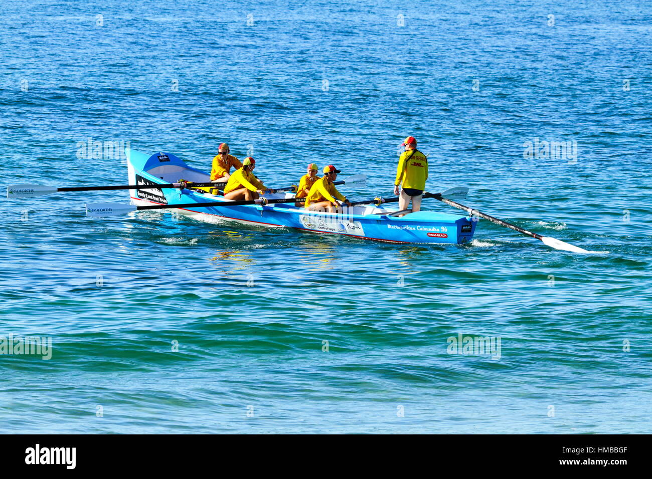 Five Surf Lifesavers launching a surf boat for some training at Kings Beach on the Sunshine Coast of Queensland, Australia. Stock Photo