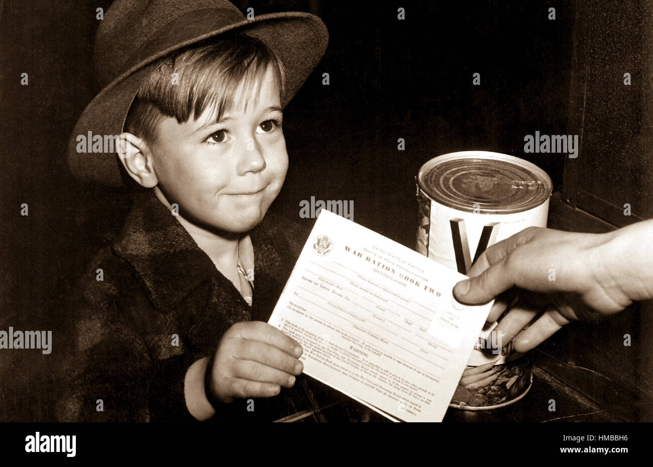 An eager school boy gets his first experience in using War Ration Book Two.  With many parents engaged in war work, children are being taught the facts of point rationing for helping out in family marketing.  February 1943.  Alfred Palmer. (OWI) Exact Date Shot Unknown NARA FILE #:  208-AA-322H-1 WAR & CONFLICT #:  792 Stock Photo