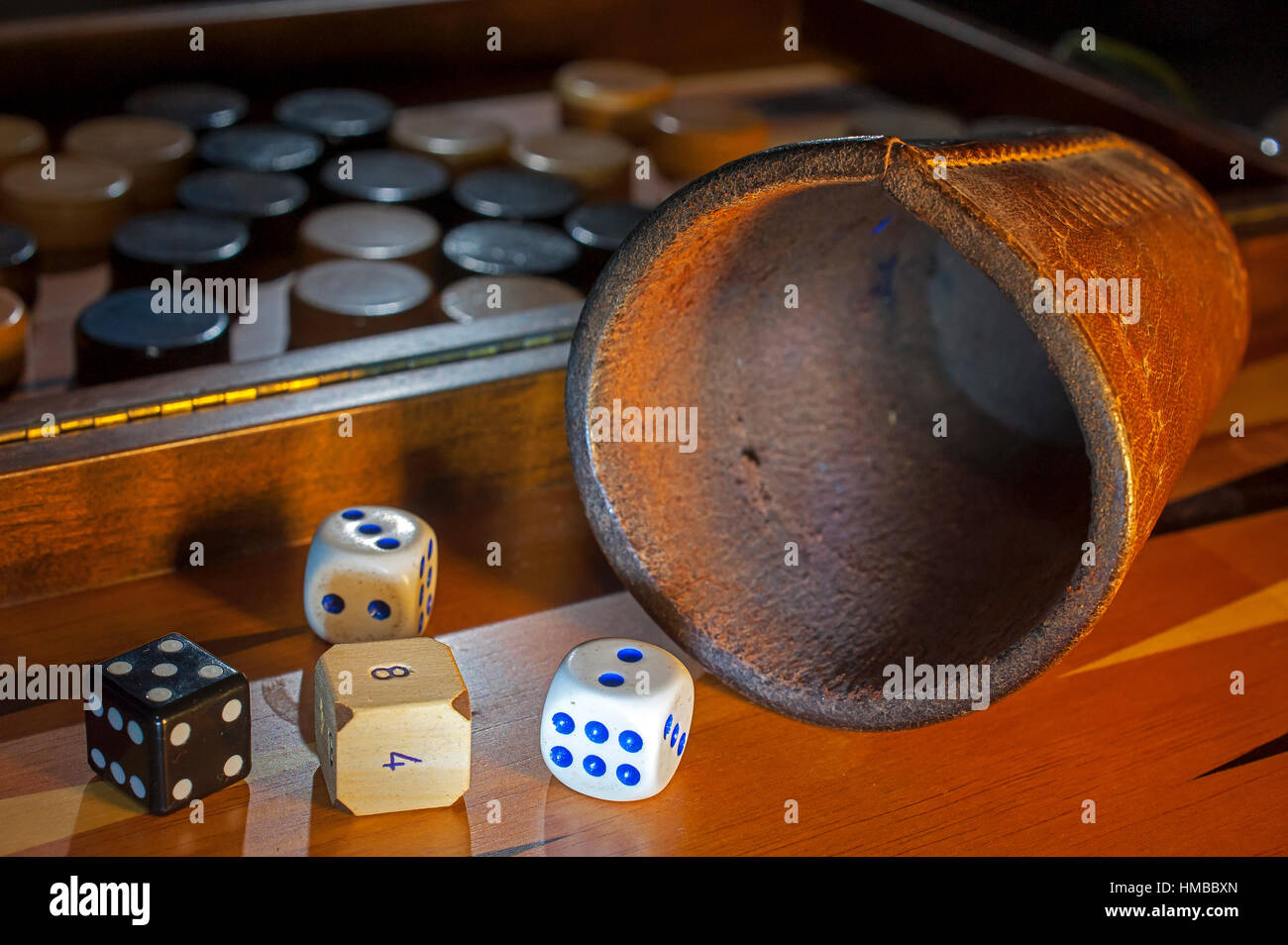 Different type of dice on a gamon board Stock Photo