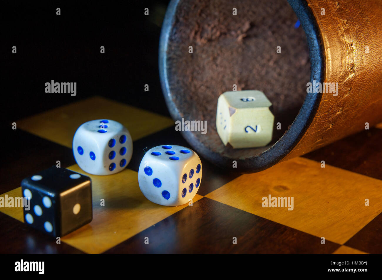 Different type of dice on a chess board Stock Photo