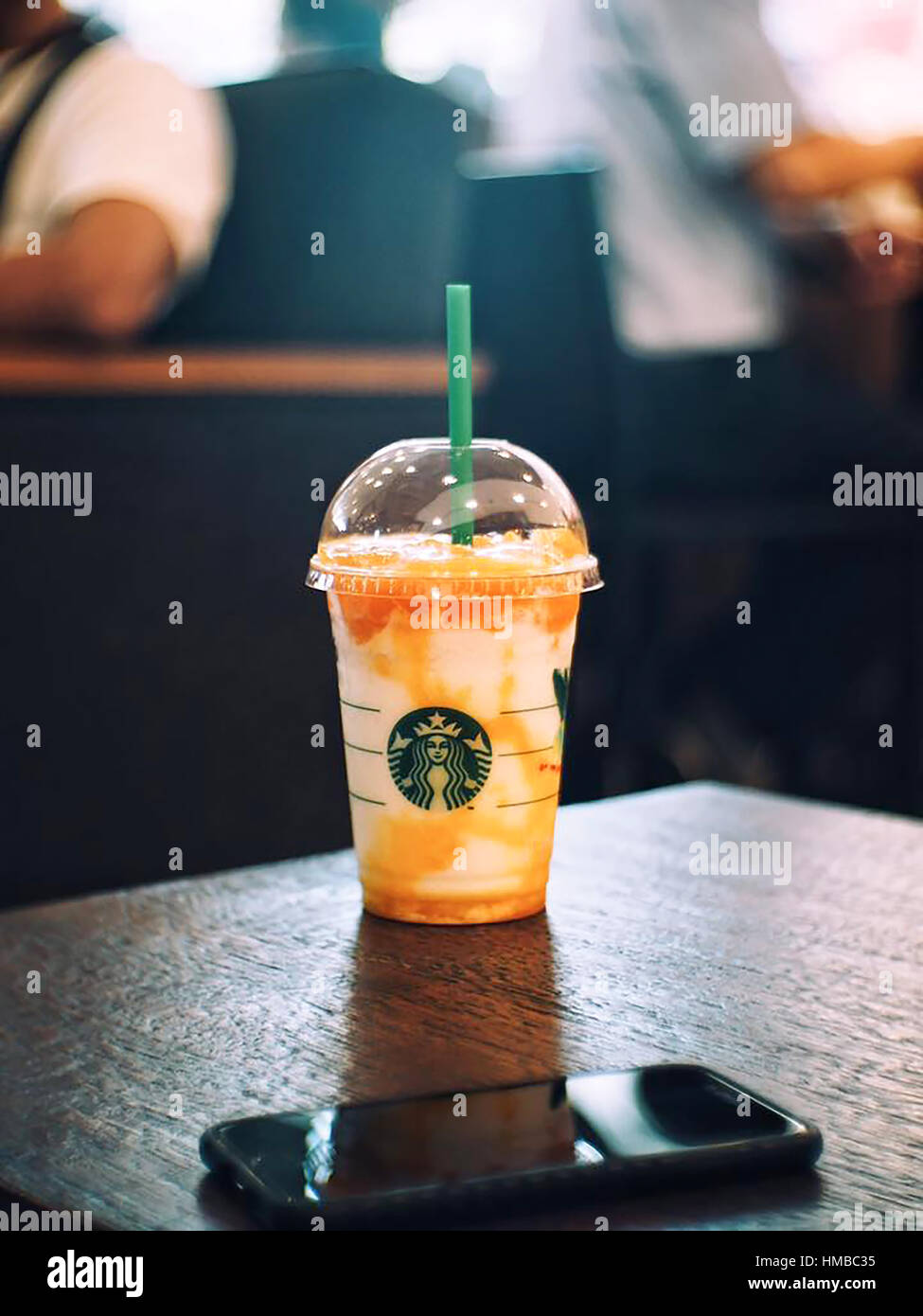 Bangkok, Thailand - Dec 25, 2016 : A cup of Starbuck Coffee Beverages.  iced latte Teavana and mobilephone background. Stock Photo