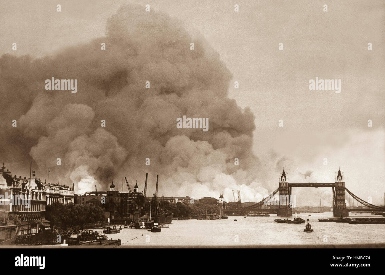 This picture, taken during the first mass air raid on London, 7th Sept. 1940, describes more than words ever could, the scene in London's dock area.  Tower Bridge stands out against a background of smoke and fires. Stock Photo