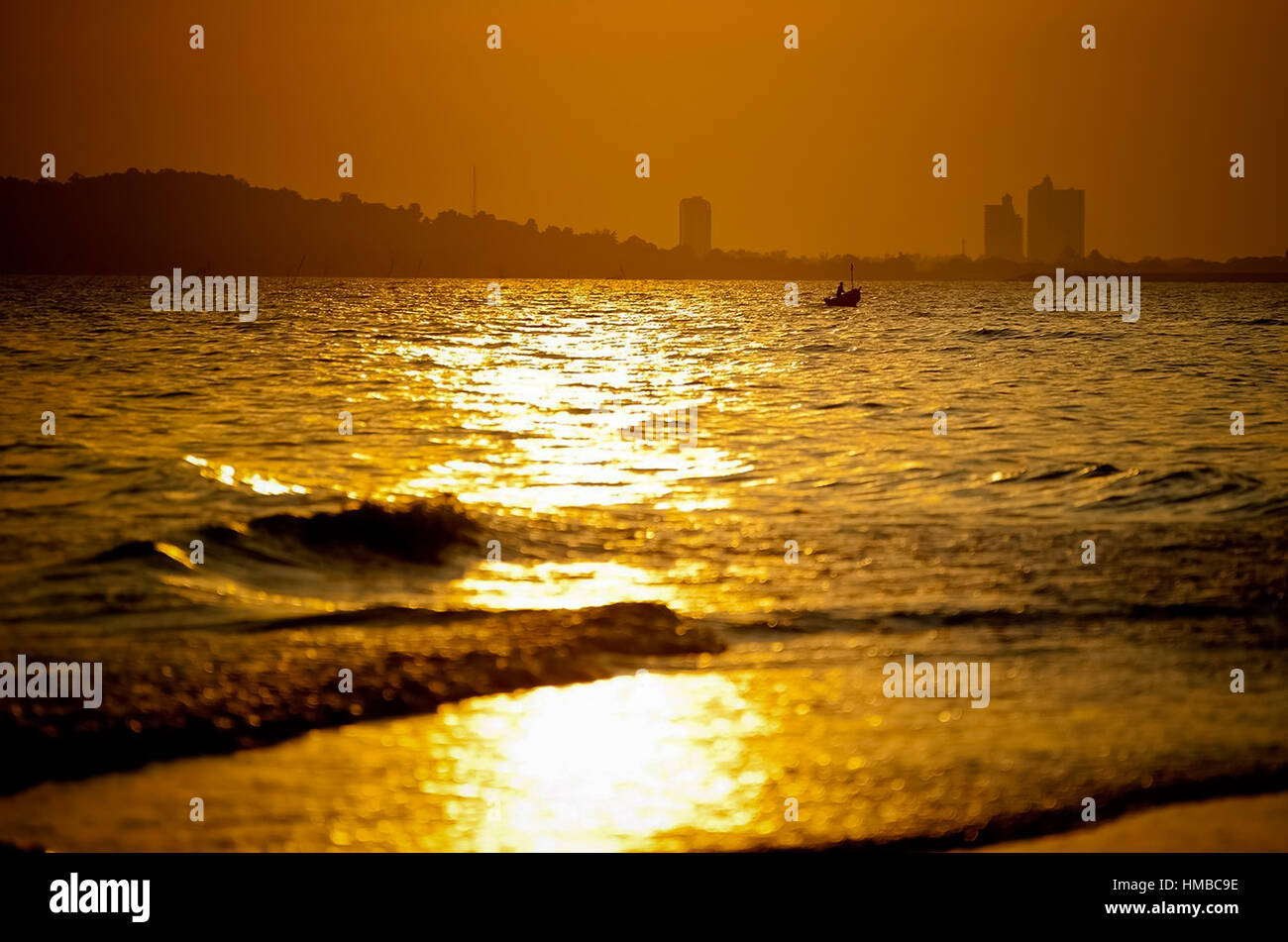 Boat in the sea at sunset time Stock Photo - Alamy