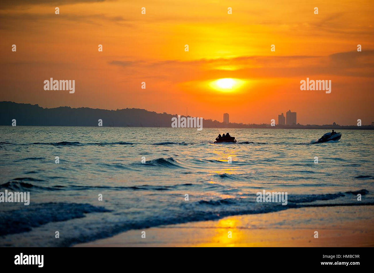 Boat in the sea at sunset time Stock Photo - Alamy