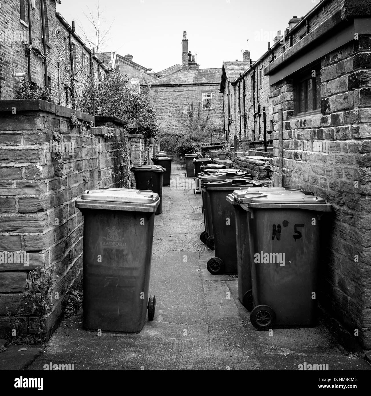 The back alley full of wheelie bins, in the traditional Victorian northern mill town of Saltaire