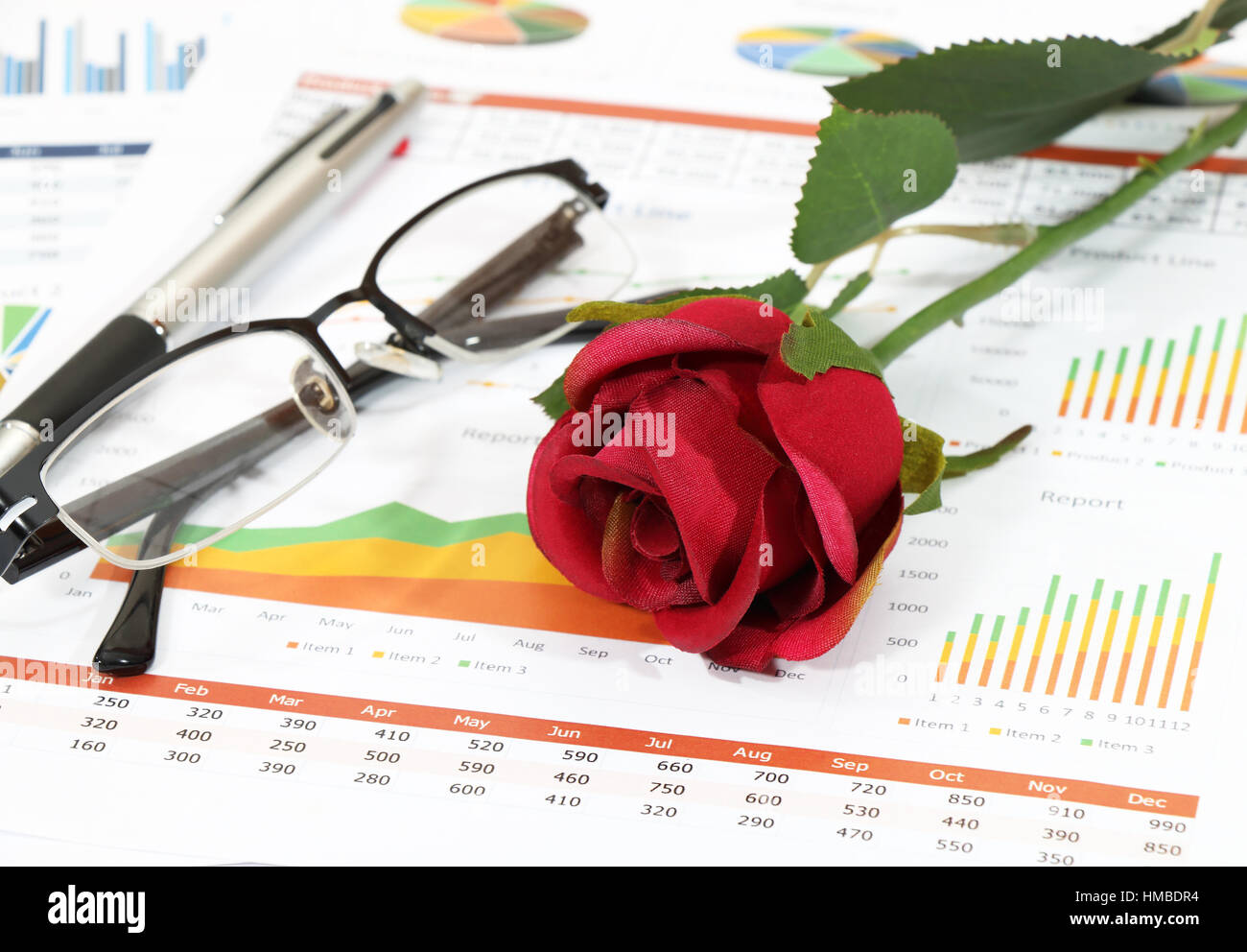 closeup Image of red rose on graph and chart report at the office Stock ...