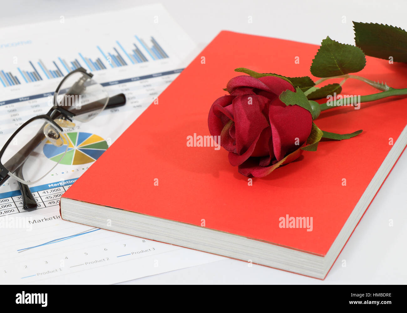 closeup Image of red rose on graph and chart report at the office Stock ...