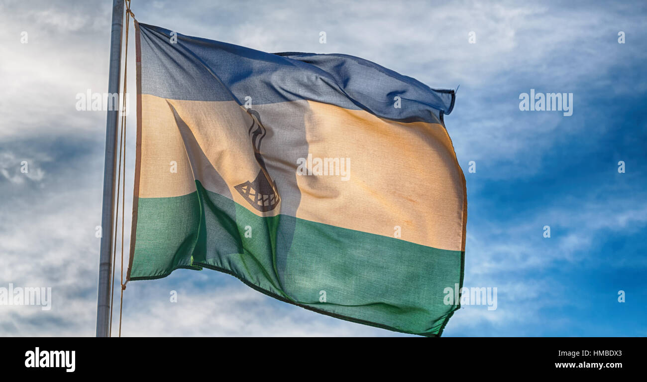 blur in lesotho waving national flag in the cloudy sky Stock Photo - Alamy