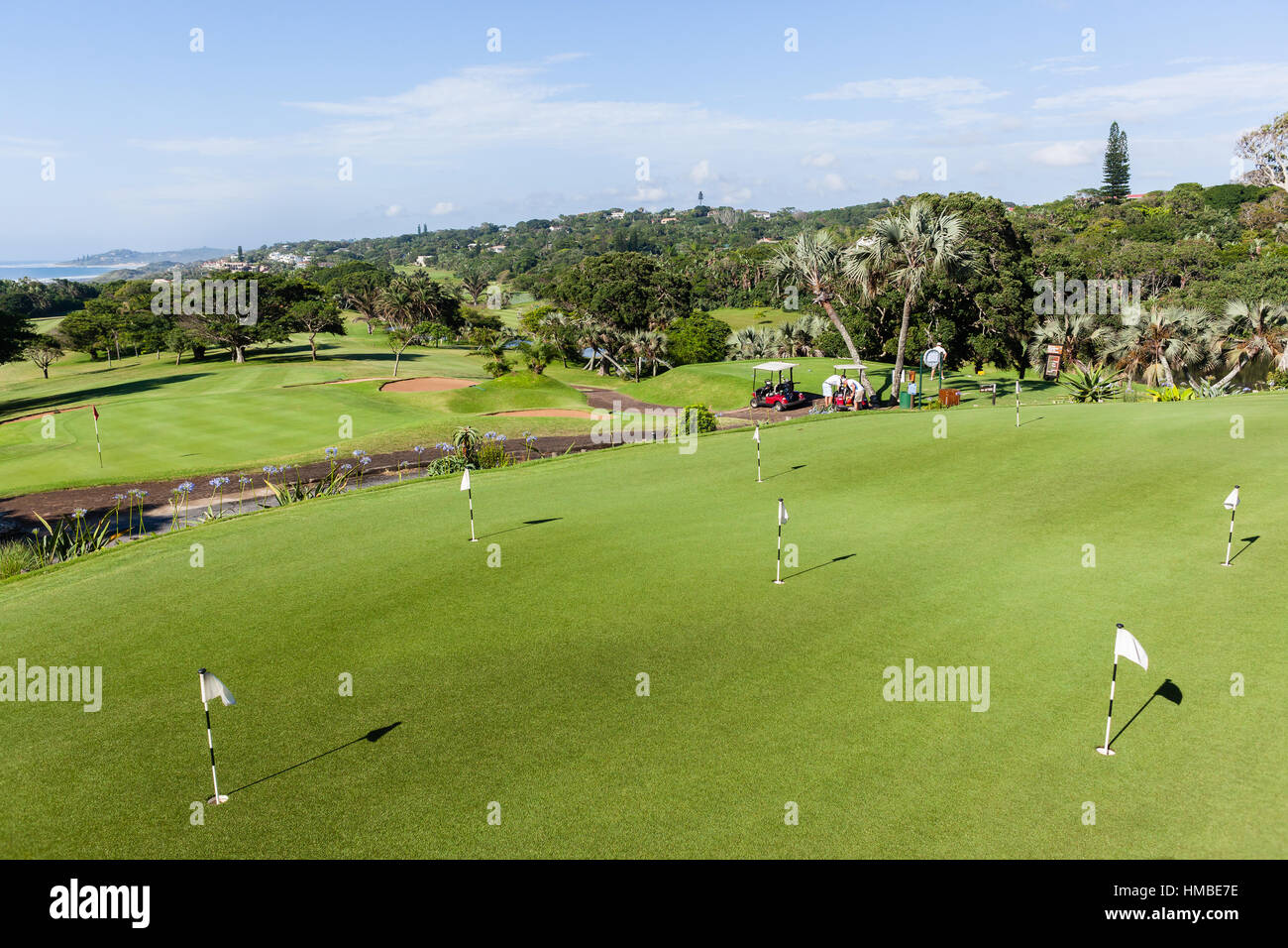 Golf course practice putting green flags stick summer sporting venue