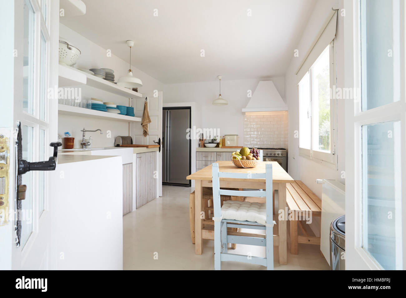 Modern Kitchen Viewed Through Open French Windows Stock Photo