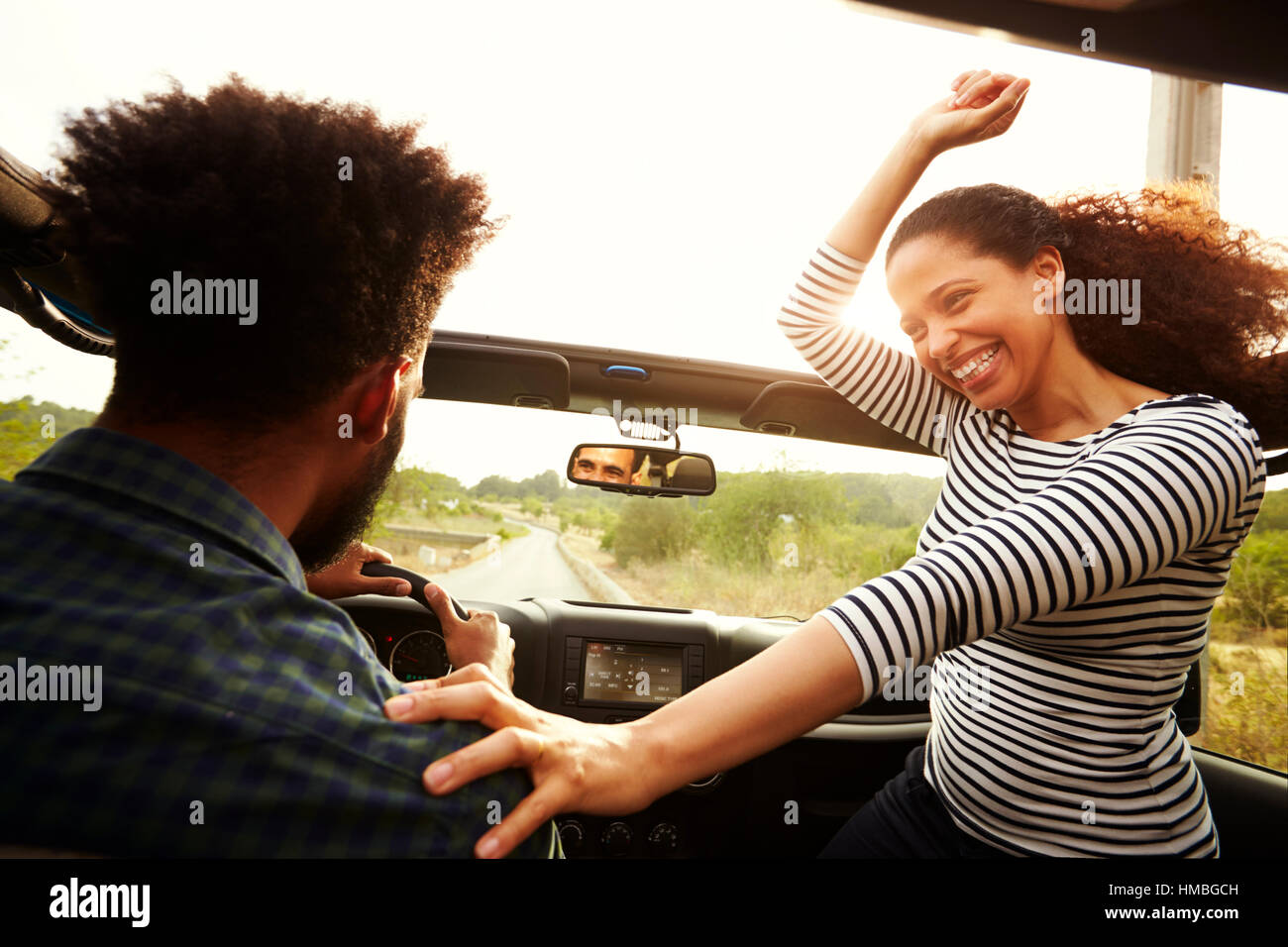 Man driving with excited woman passenger in front of car Stock Photo ...