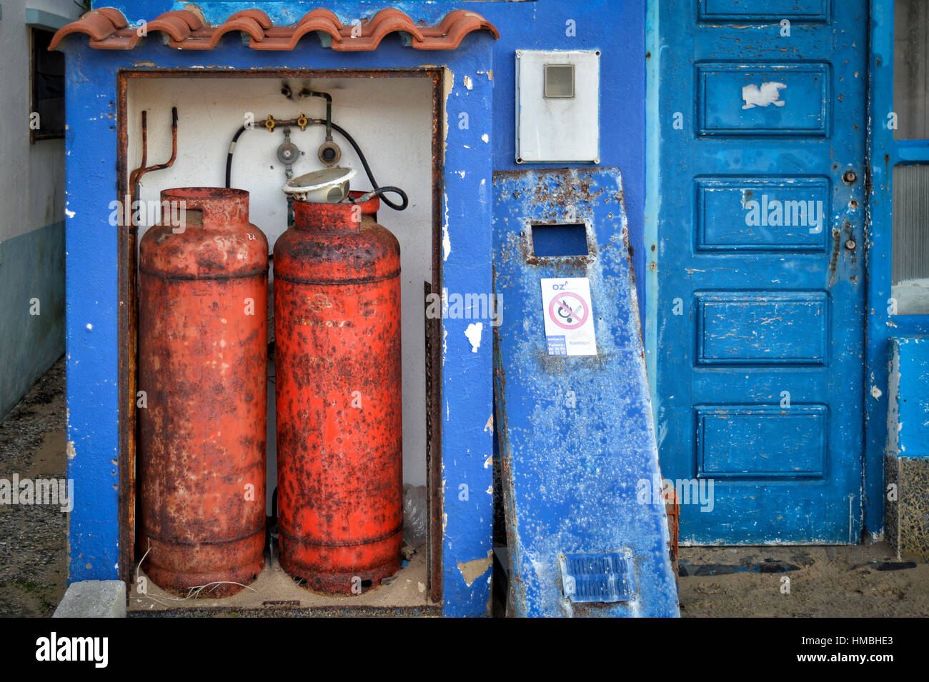 rusty gas fuel canisters outside a building Stock Photo