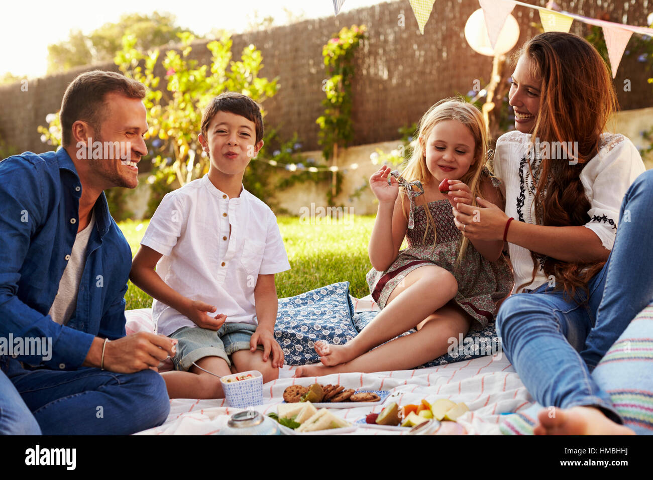Two girls sitting on picnic blanket hi-res stock photography and images ...