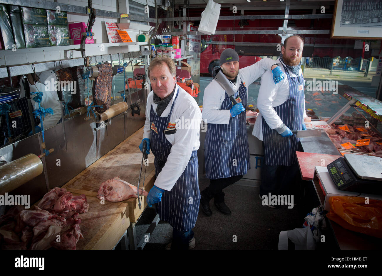 Butchers pose outside their butcher shop in London Stock Photo - Alamy