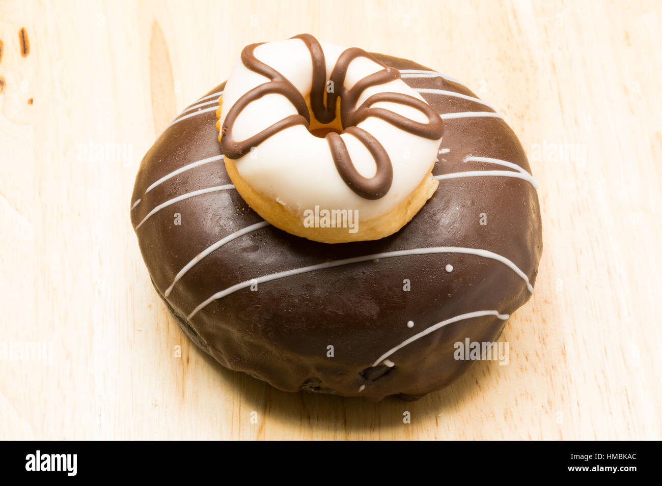 Small and large delicious donuts on wooden board Stock Photo