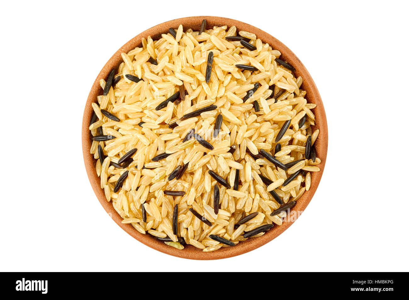 Brown and black rice in ceramic bowl on white Stock Photo