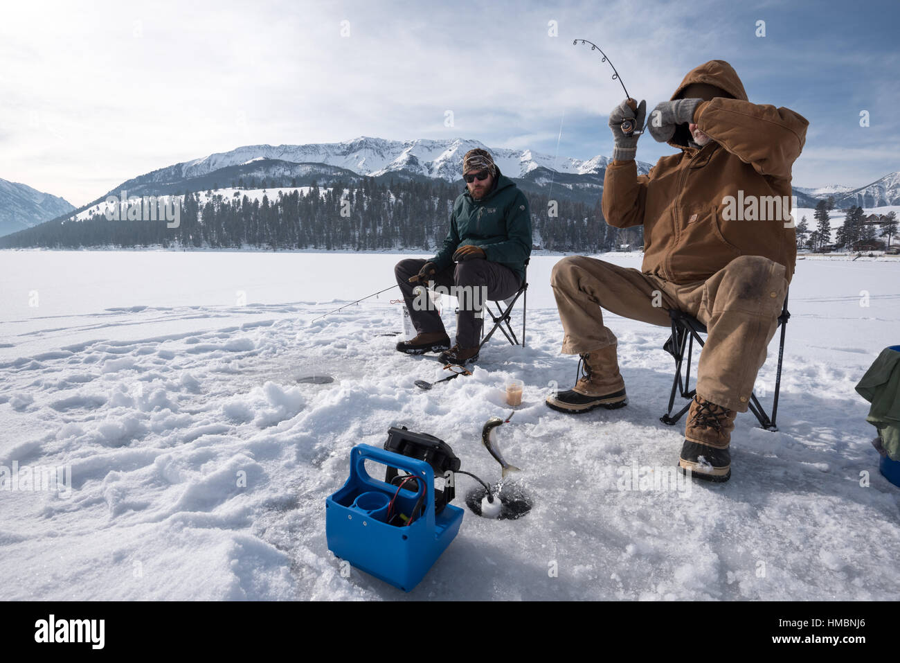 Catching a kokanee salmon ice fishing on Wallowa Lake, Oregon Stock