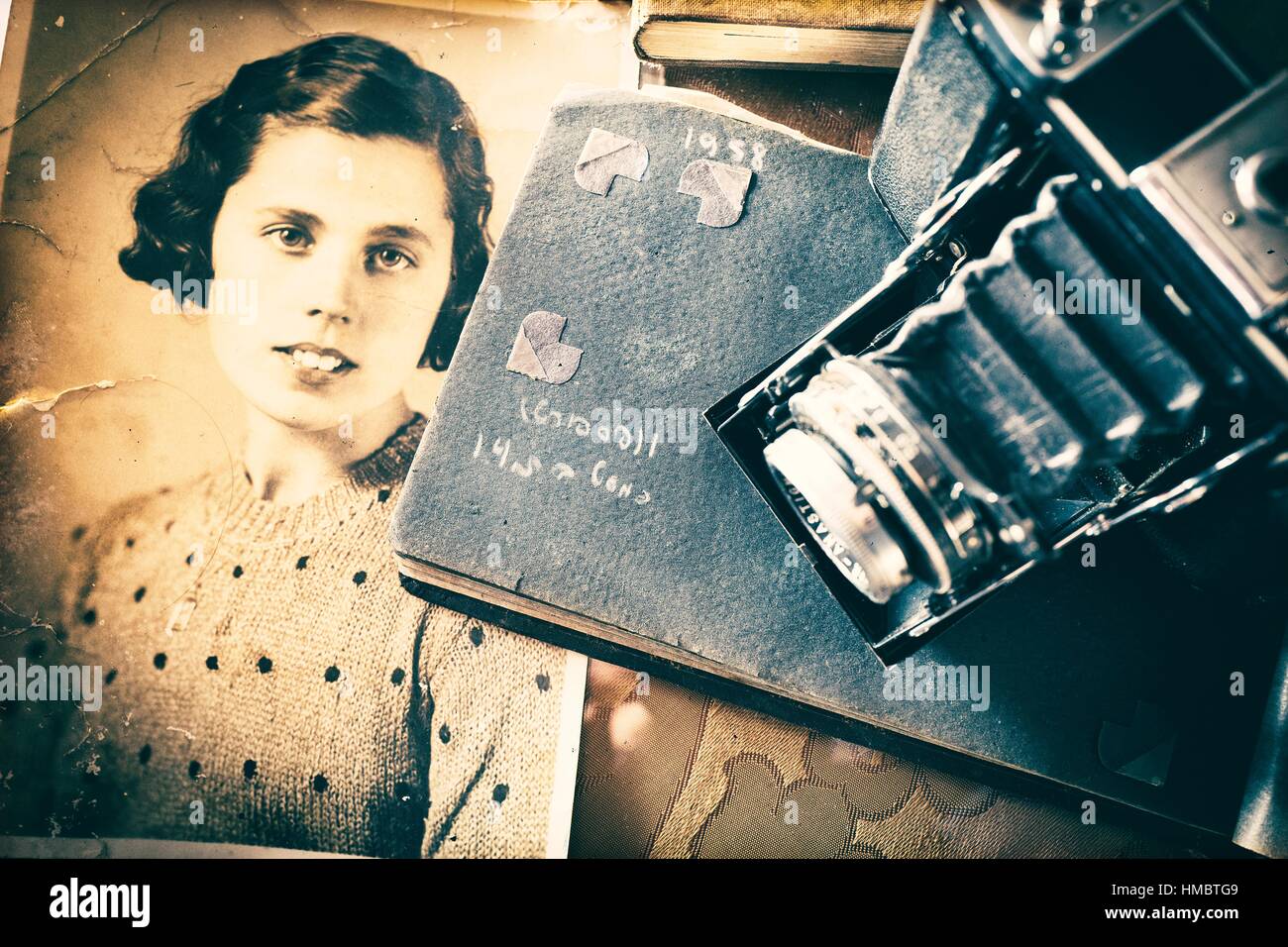 Old black and white portrait of woman with photo album and vintage