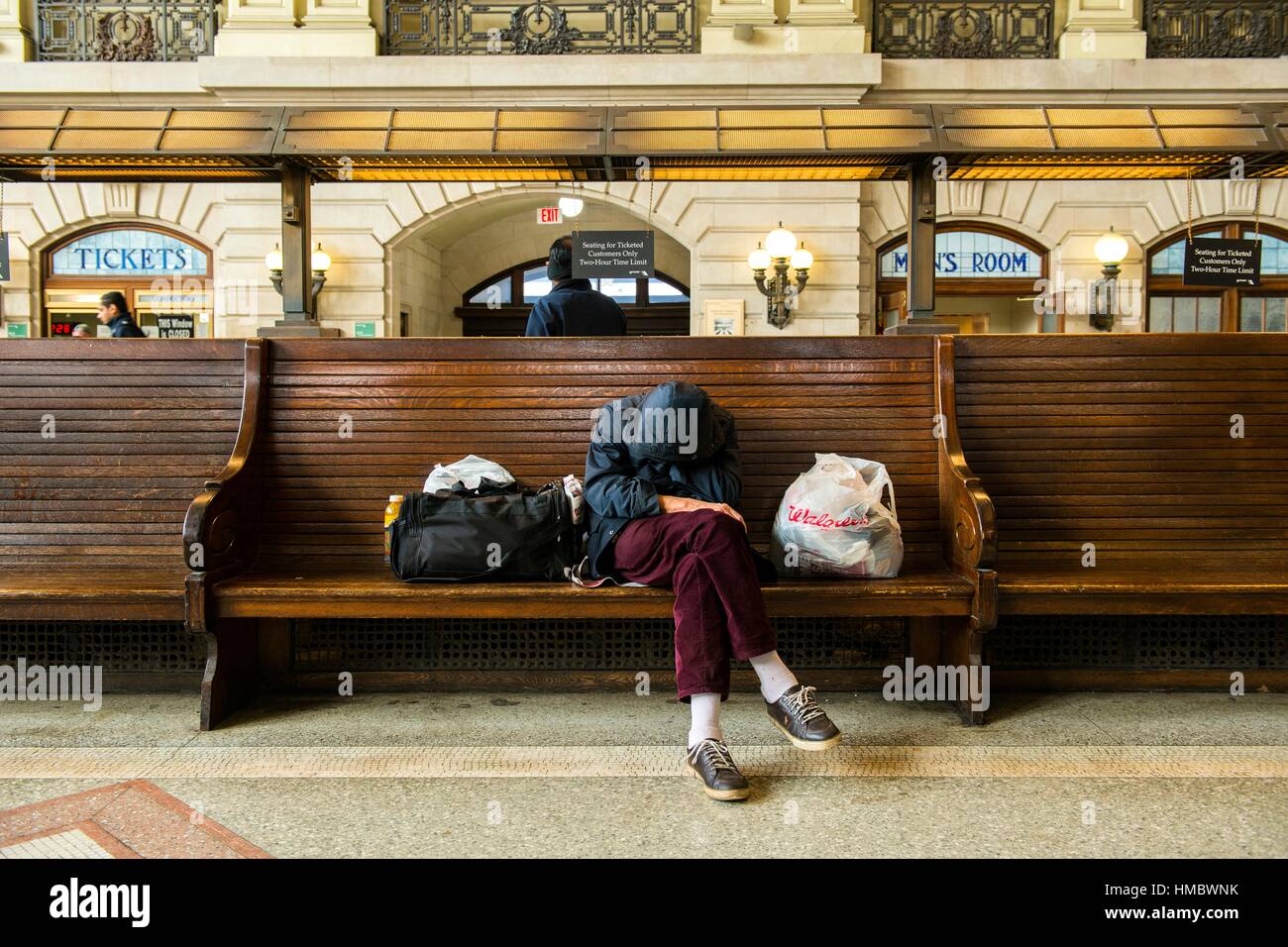 Jersey City, New Jersy, USA. Homeless man sleeping on the benches of