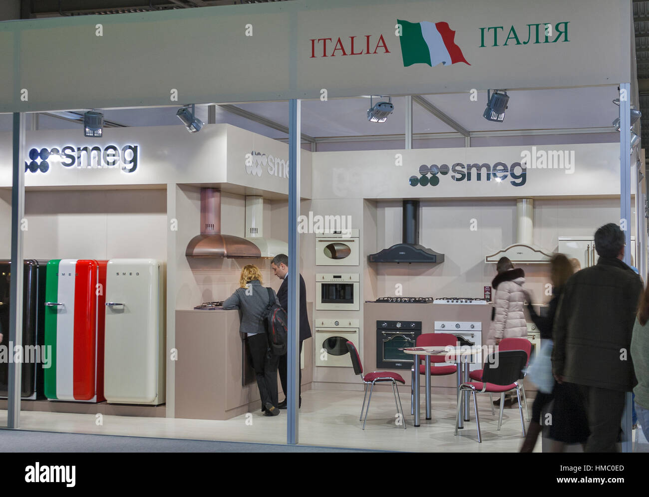 Visitors visit Smeg Italian home appliance manufacturer booth display at Kiev International Furniture Forum at Kyiv Expo Plaza Exhibition Center in Ki Stock Photo