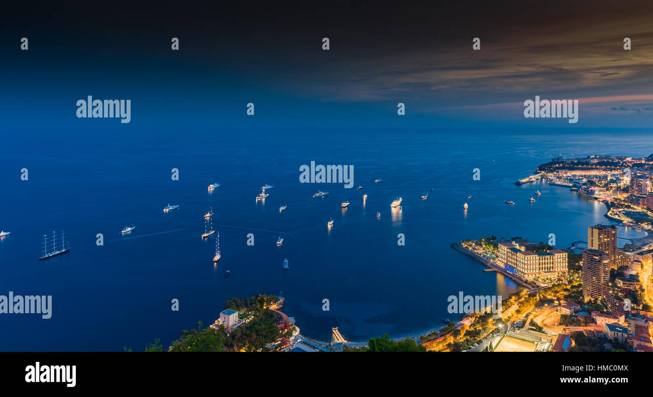 Monaco, Monte-Carlo, 26 September 2016: Aerial panoramic view the night city from hotel Vista, night illumination of yachts, streets, buildings, long  Stock Photo