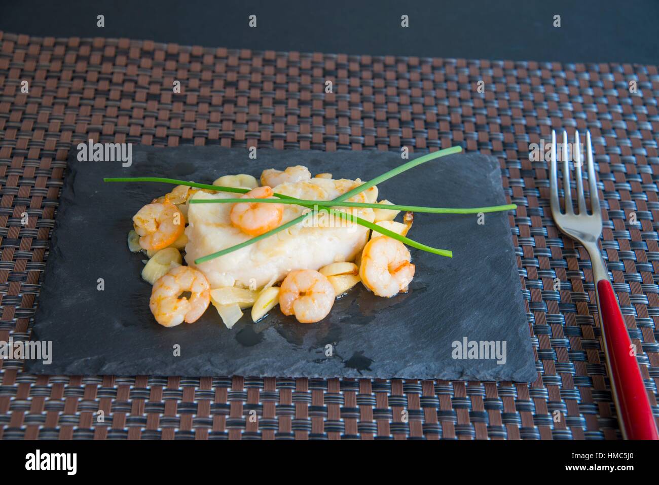 Hake loin with prawns, garlic and spring onions Stock Photo Alamy